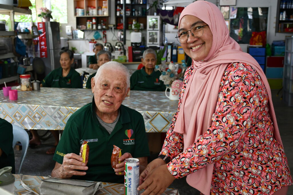 TCMH team serving the residents light snacks, bringing smile to their faces