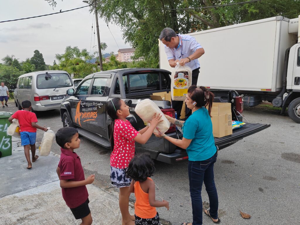 TCIE team distributing the donated items to the children