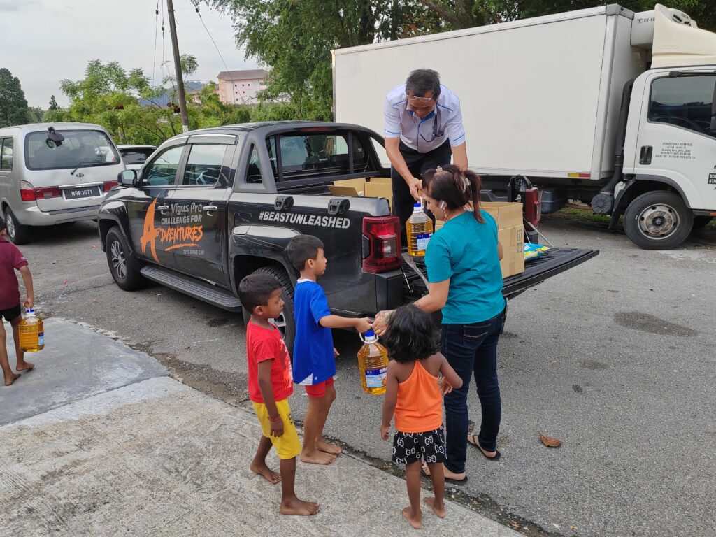 TCIE team distributing the donated items to the children